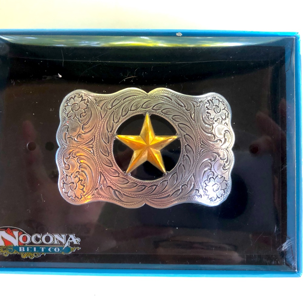Woman’s Nocona belt buckle silver with gold star.